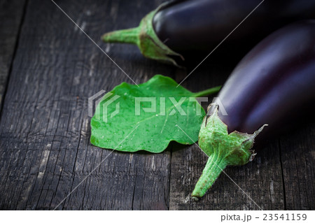 Fresh aubergine on vintage wood background 23541159