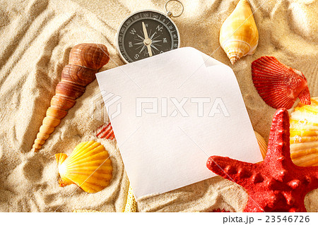 Seashells, compass and paper on sand Seashells, compass and paper on sand 23546726