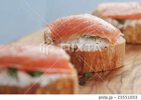 small sandwiches with soft cheese and salmon 23551033