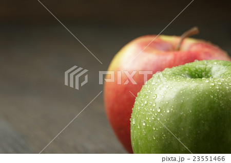 two ripe apples on wood table 23551466