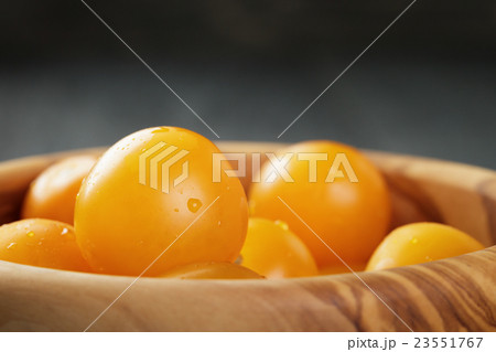 yellow cherry tomatoes in wood bowl yellow cherry tomatoes in wood bowl 23551767