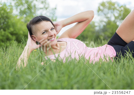 Young female athlete excercising and stretching in Young female athlete excercising and stretching in 23556247