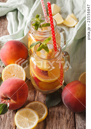 Refreshing drink with lemon, peach, ice and mint Refreshing drink with lemon, peach, ice and mint 23556847