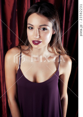 young pretty stylish woman fancy dressed at red young pretty stylish woman fancy dressed at red 23562231