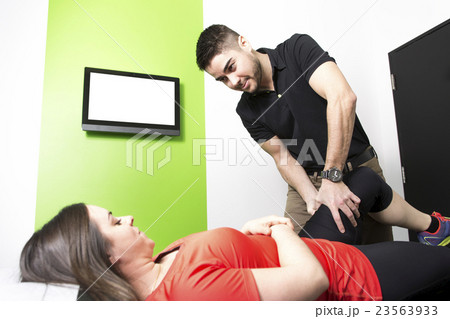Male Osteopath Treating Female Patient With Hip Male Osteopath Treating Female Patient With Hip 23563933