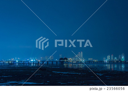 It is a city at night, with the sea terminals. It is a city at night, with the sea terminals. 23566056