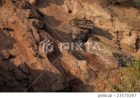 Waste heaps of red rock in industrial district 23570267