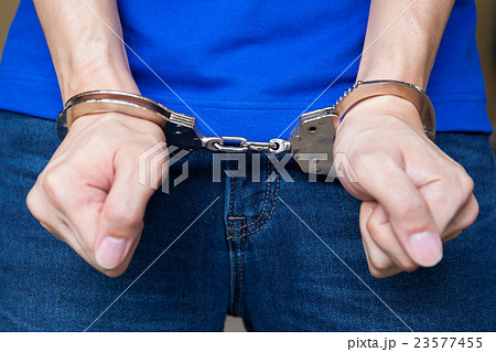 Handcuffed hands Closeup shot Handcuffed hands Closeup shot 23577455