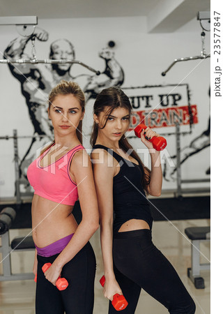 Two beautiful girl with dumbbells Two beautiful girl with dumbbells 23577847