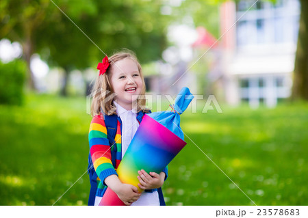 Little child with candy cone on first school day Little child with candy cone on first school day 23578683