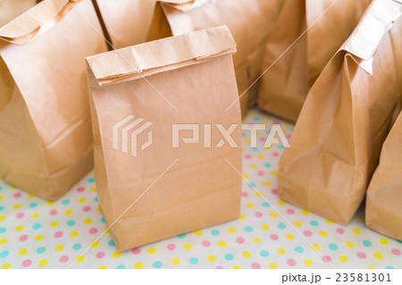 Brown paper bags on table . 23581301