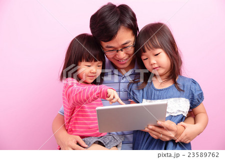 father and daughter using tablet father and daughter using tablet 23589762
