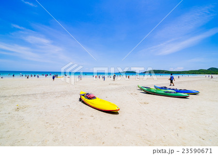Surfer on Pretty beach and ocean with sailboat Surfer on Pretty beach and ocean with sailboat 23590671