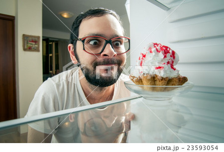 funny man sees the sweet cake in the fridge funny man sees the sweet cake in the fridge 23593054