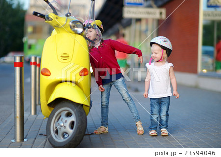 Two very curious little girls and a motorcycle 23594046