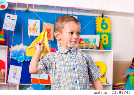 Child playing with origami airplane in primary Child playing with origami airplane in primary 23595746