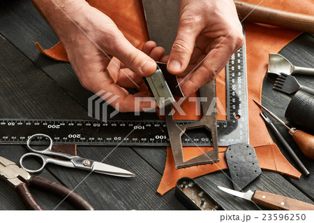 Man working with leather Man working with leather 23596250
