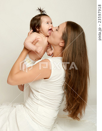 Mom throws baby baby and kiss, play and having fun 23597918