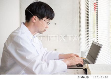 デスクワークをする白衣の男性 23603938