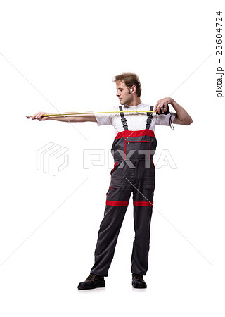 Young repairman with tape measure isolated on Young repairman with tape measure isolated on 23604724