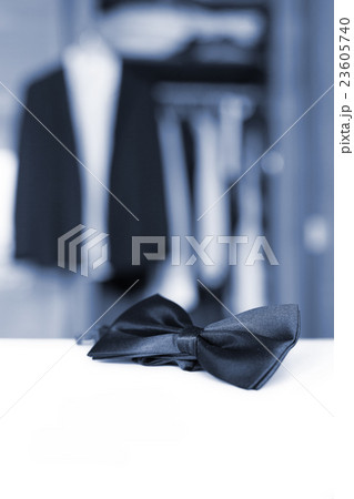 Bow tie. Open closet and tuxedo.  23605740