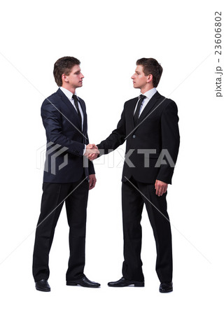 Two twin brothers handshaking isolated on white Two twin brothers handshaking isolated on white 23606802