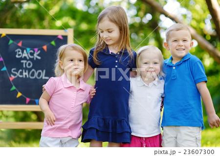 Four excited little kids by a chalkboard 23607300