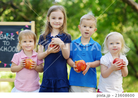 Four excited little kids by a chalkboard Four excited little kids by a chalkboard 23608600