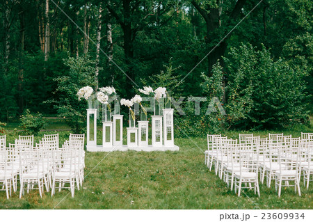 wedding ceremony in a beautiful garden. white wedding ceremony in a beautiful garden. white 23609934