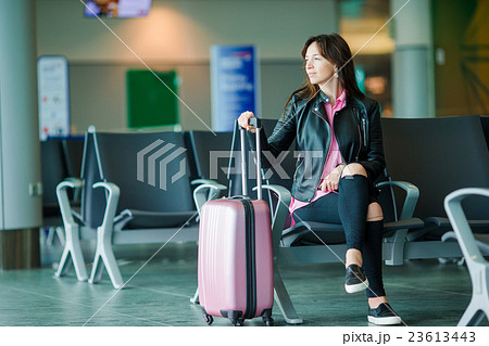 Airline passenger in an airport lounge waiting for Airline passenger in an airport lounge waiting for 23613443