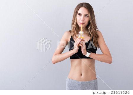 Positive woman drinking juice 23615526