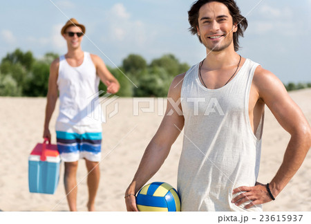 Joyful friends resting on the beach Joyful friends resting on the beach 23615937