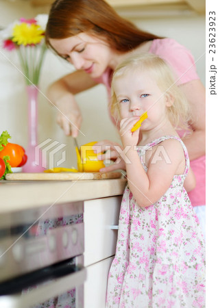 Mother and daughter cooking dinner 23623923