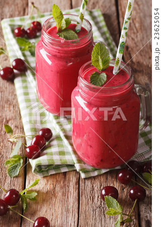 cherry milkshake with a straw in a glass jar cherry milkshake with a straw in a glass jar 23625054