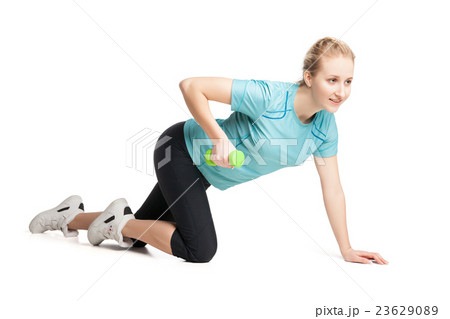 Athletic young woman works out with green 23629089