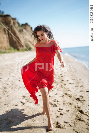 Attractive girl in a smart dress red Attractive girl in a smart dress red 23632961