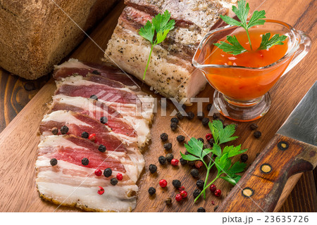 salty bacon on a cutting board salty bacon on a cutting board 23635726