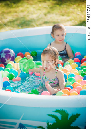The two little baby girls playing with toys in 23642781