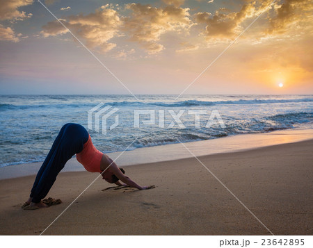 Woman doing yoga Surya Namaskar oudoors at 23642895