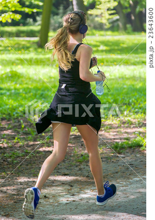 Young female jogger with headphones Young female jogger with headphones 23643600