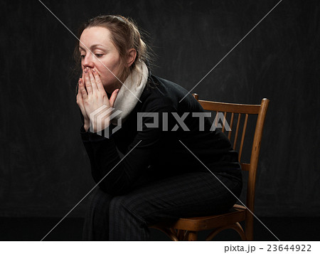 Young sad disoriented woman sitting on the chair Young sad disoriented woman sitting on the chair 23644922