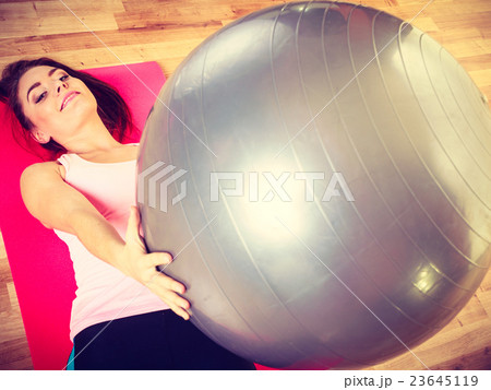 Young lady exercising on the mat. Young lady exercising on the mat. 23645119