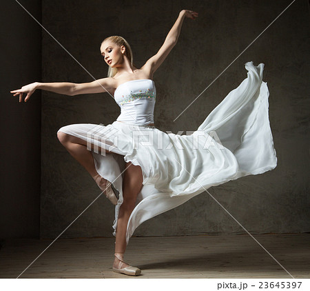 Beautiful ballet dancer in white costume with 23645397