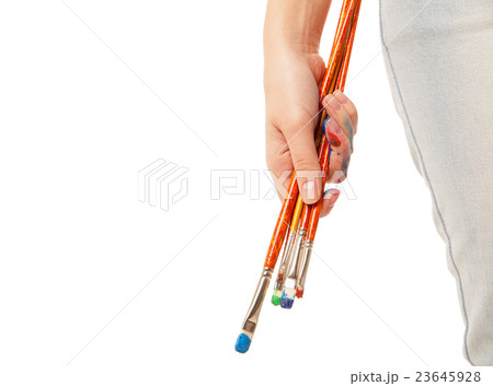 Hand holding brushes isolated on white 23645928
