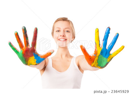 Woman looks out palms painted in colorful paint  23645929