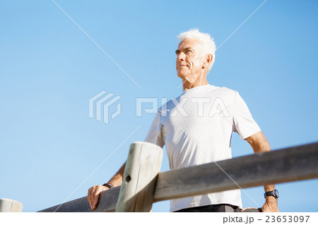 Man standing on beach in sports wear 23653097