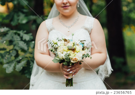 beautiful bouquet in hands of the very fat bride 23656765
