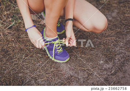 Runner woman tying shoelaces. Tie shoelaces Runner woman tying shoelaces. Tie shoelaces 23662758