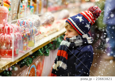 Little kid boy with candy cane stand on Christmas 23663821