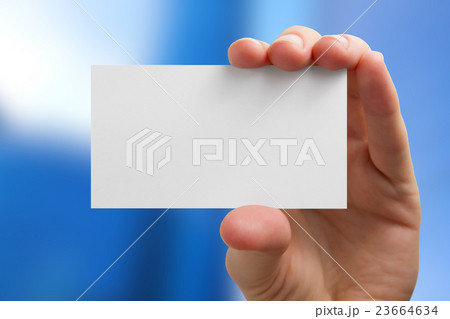 Hand holding white business card on blurred 23664634